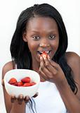 Bright Afro-american a woman eating strawberries