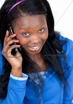 Portrait of a woman talking on phone sitting on the floor