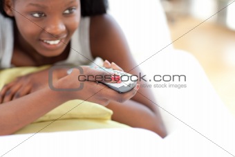 Young woman watching TV in the living-room