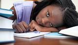 Exhausted Afro-American woman resting while studying