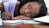 Exhausted teen girl resting while studying 