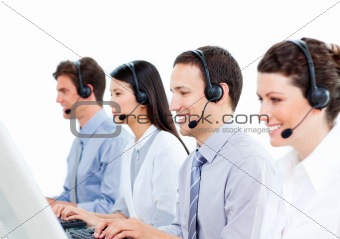 Smiling customer service agents working in a call center