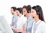 Joyful customer service agents working in a call center
