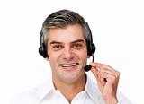 Mature businessman using headset 