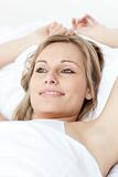 Charming woman relaxing  lying on a bed 