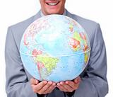 Close-up of a businessman holding a terrestrial globe 