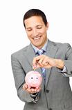 Young businessman saving money in a piggy-bank