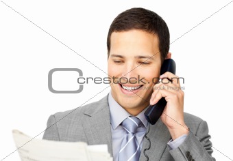 Charsmatic businessman on phone holding a newspaper 