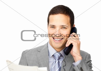 Attractive businessman on phone holding a newspaper 