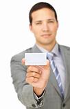 Serious male executive holding a white card 
