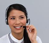 Smiling ethnic customer service talking on a headset