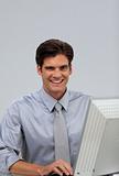 Cheerful businessman working at a computer 