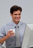 Positive businessman holding a drinking cup 