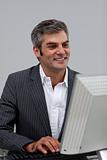 Mature male executive working at a computer 