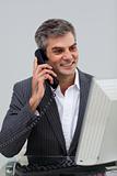 Positive male executive talking on phone 