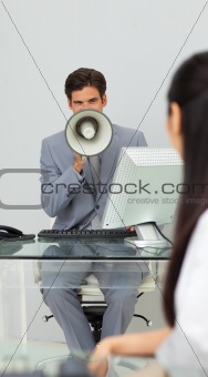 Businessman giving instructions with a megaphone 