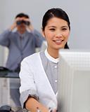 Self-assured asian businesswoman at a computer