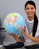 Assertive businesswoman holding terrestrial globe