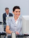 Smiling business woman working at a computer
