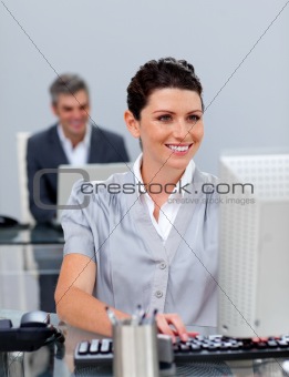 Smiling business woman working at a computer