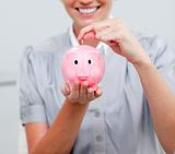 Close-up of a woman holding a piggy bank