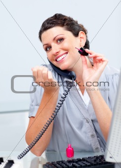 Attractive business woman on phone painting her nails