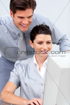 Confident business woman and her colleage working at a computer