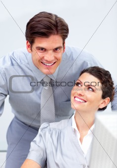 Enthusiastic business team working at a computer 