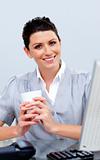 Smiling business woman drinking coffee