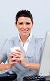 Positive business woman drinking coffee