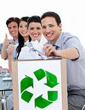 Young business people showing the concept of recycling