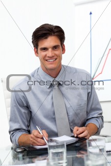 Male executive consulting his agenda in a meeting 