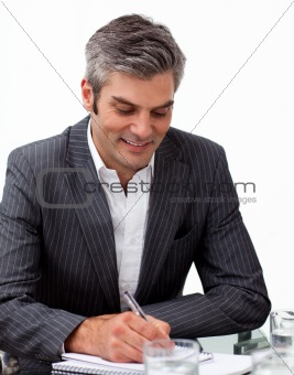Assertive mature businessman studying a document 