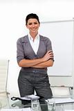 Self-assured female executive with folded arms