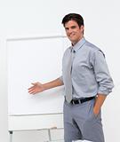 Self-assured businessman pointing at a board 