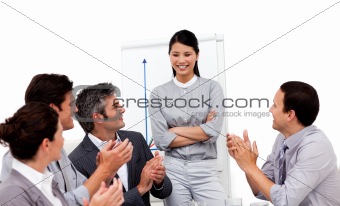 Smiling businesswoman applauded for her presentation