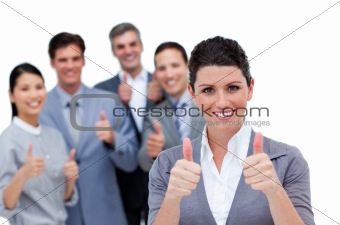 A diverse business team with thumbs up 