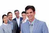Smiling businessman standing in front of his team