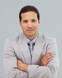 Young businessman with folded arms in front of the camera