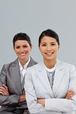 Confident businesswomen with folded arms standing