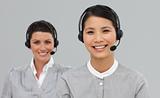 Two attractive businesswomen with headset on