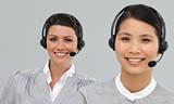 Smiling young businesswomen with headset on 