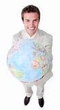 Positive businessman showing a terrestrial globe 