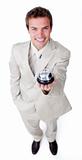 Assertive young businessman holding a service bell 