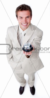 Assertive young businessman holding a service bell 