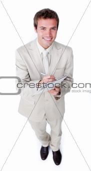 Charismatic young businessman holding a newspaper 