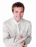 Smiling caucasian businessman holding a newspaper 