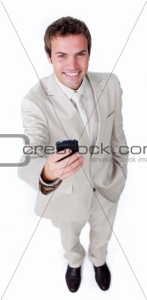 Smiling charismatic businessman sending a text 