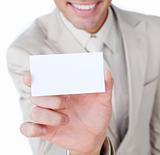 Close-up of a businessman holding a white card 