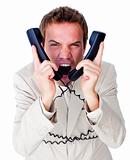 Stressed businessman tangle up in phone wires